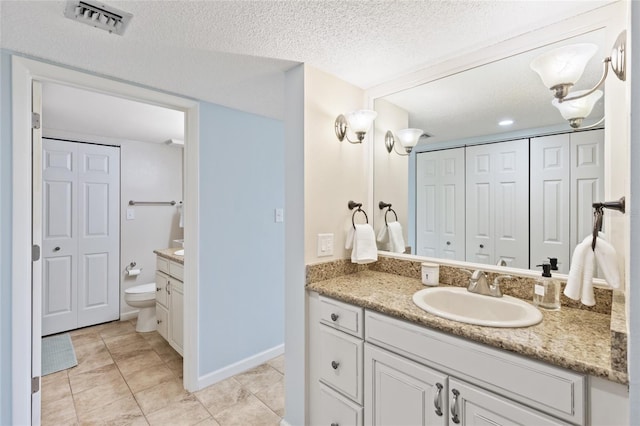 6265 Midnight Pass Rd Unit 205, Sarasota, FL 34242 - bathroom featuring a closet, vanity, a textured ceiling, and tile patterned flooring
