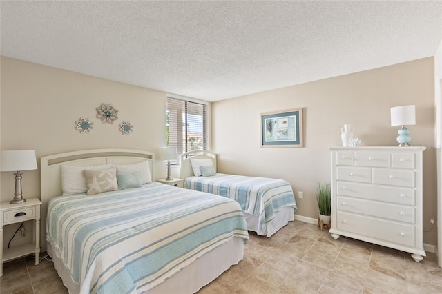 6265 Midnight Pass Rd Unit 205, Sarasota, FL 34242 - bedroom featuring a textured ceiling and light tile patterned floors