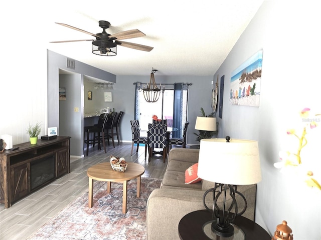 4001 Beneva Rd Unit 319, Sarasota, FL 34233 - living area featuring a ceiling fan, wood tiled floors, and a chandelier