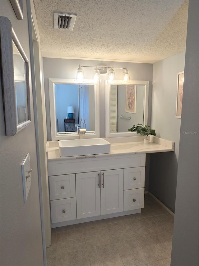 4001 Beneva Rd Unit 319, Sarasota, FL 34233 - bathroom with a textured ceiling, vanity, and tile patterned flooring