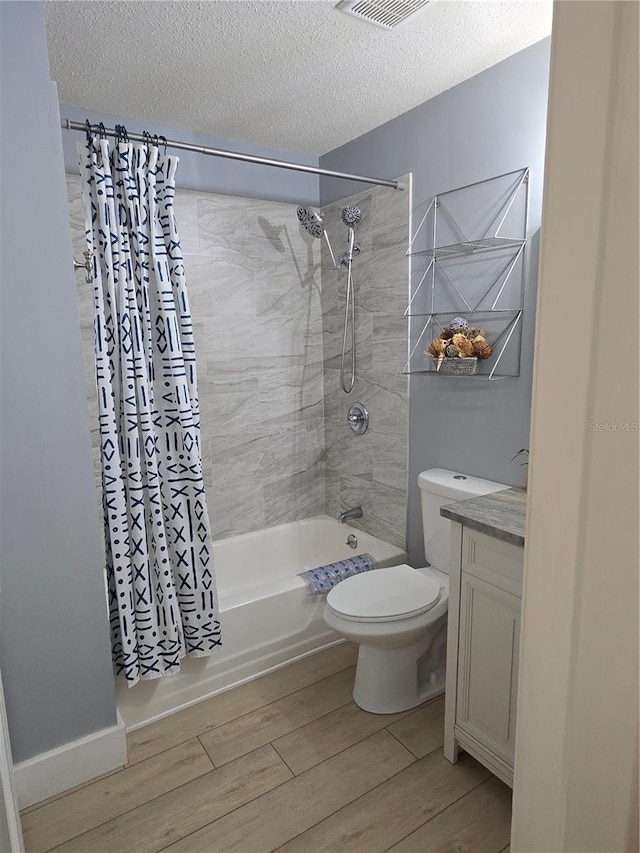 4001 Beneva Rd Unit 319, Sarasota, FL 34233 - full bathroom featuring wood finished floors, shower / bath combo with shower curtain, a textured ceiling, and vanity