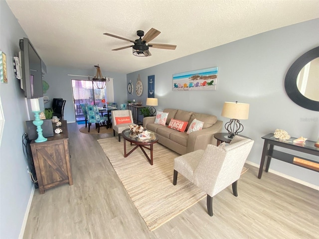 4001 Beneva Rd Unit 319, Sarasota, FL 34233 - living room with light wood-style flooring, a ceiling fan, and a textured ceiling