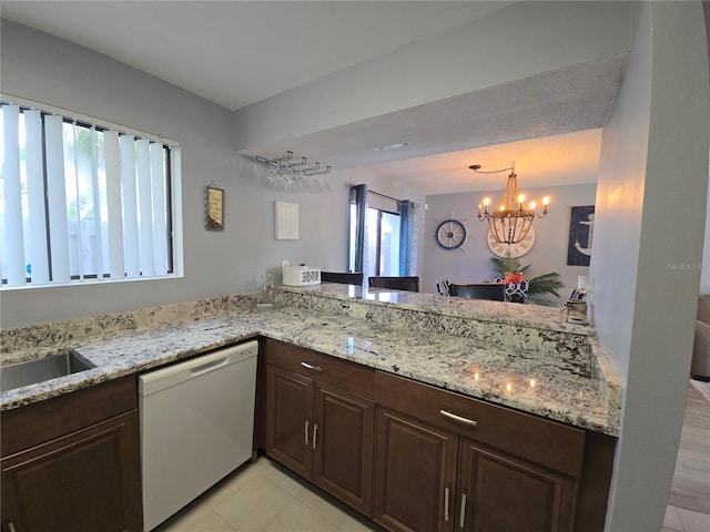 4001 Beneva Rd Unit 319, Sarasota, FL 34233 - kitchen with dishwasher, a chandelier, dark brown cabinets, light tile patterned flooring, and light stone countertops