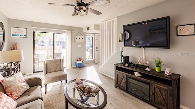 4001 Beneva Rd Unit 319, Sarasota, FL 34233 - living room with ceiling fan, light wood-style flooring, a textured ceiling, and stairway