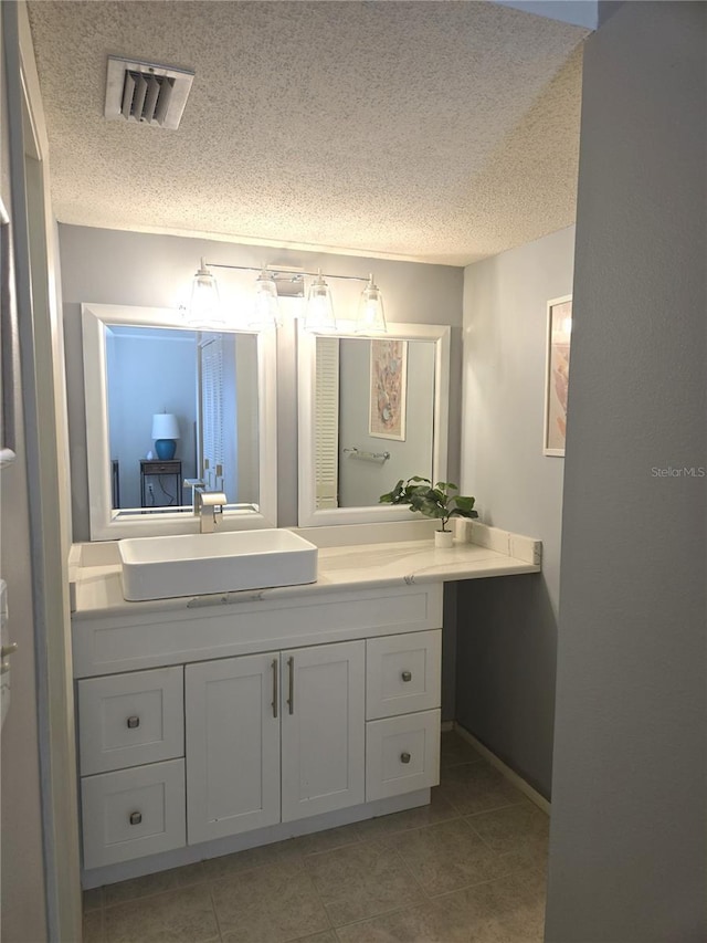 4001 Beneva Rd Unit 319, Sarasota, FL 34233 - bathroom featuring a textured ceiling, vanity, and tile patterned flooring