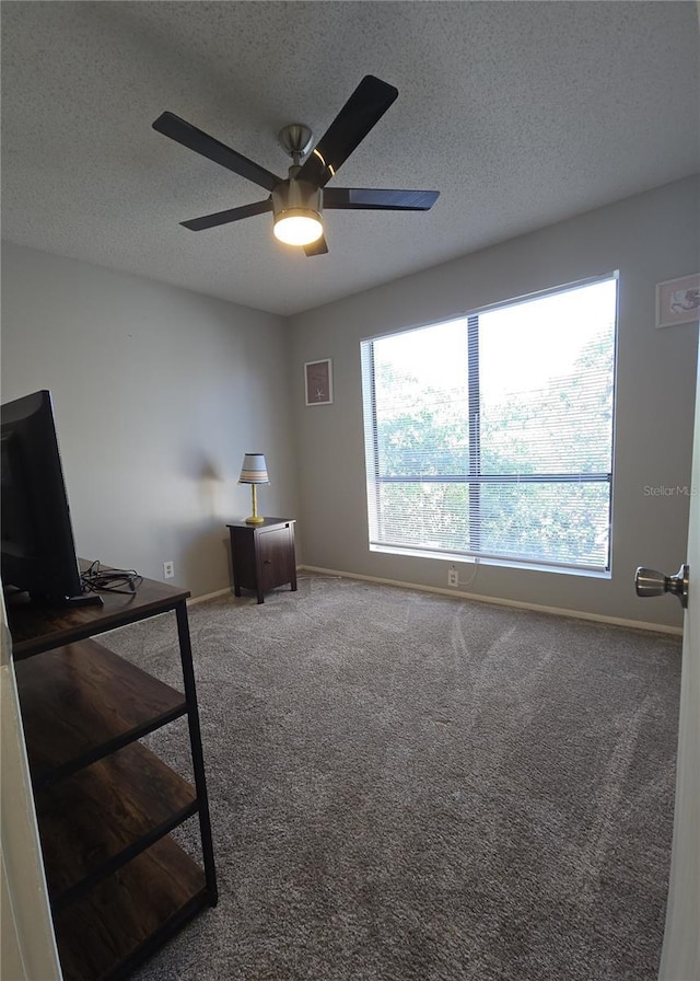 4001 Beneva Rd Unit 319, Sarasota, FL 34233 - carpeted bedroom featuring a textured ceiling, a desk, and a ceiling fan