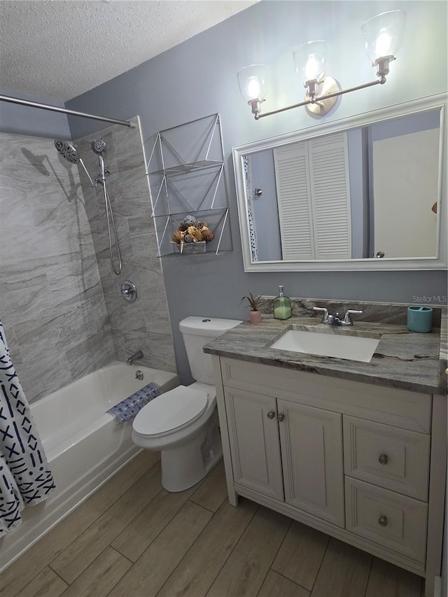 4001 Beneva Rd Unit 319, Sarasota, FL 34233 - full bath with wood finished floors, vanity, shower / tub combo with curtain, and a textured ceiling