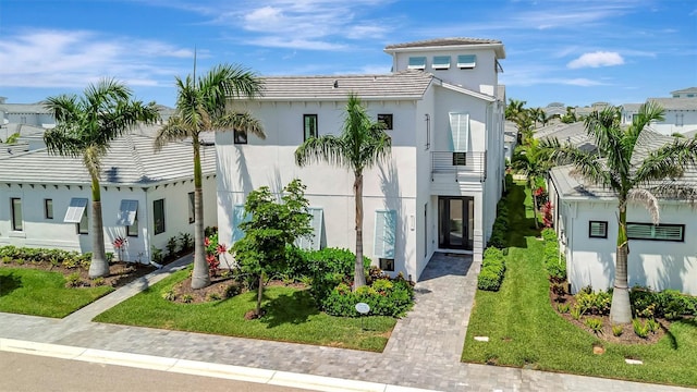 6317 Turtle Grass Dr, Bradenton, FL 34210 - view of front of house with stucco siding, a balcony, and a tiled roof