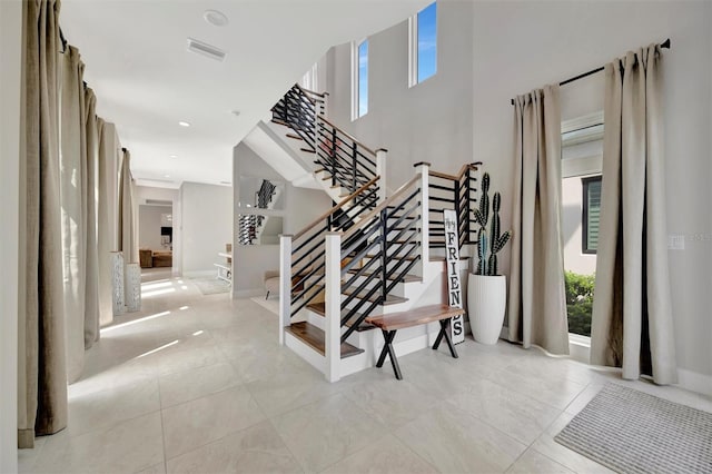 6317 Turtle Grass Dr, Bradenton, FL 34210 - stairs featuring healthy amount of natural light, tile patterned floors, and a towering ceiling