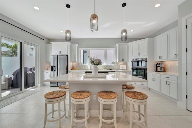 6317 Turtle Grass Dr, Bradenton, FL 34210 - kitchen with stainless steel appliances, backsplash, light countertops, a kitchen breakfast bar, and a kitchen island