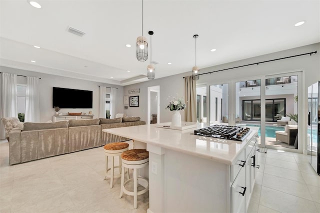 6317 Turtle Grass Dr, Bradenton, FL 34210 - kitchen with stainless steel gas stovetop, open floor plan, healthy amount of natural light, a kitchen island, and recessed lighting