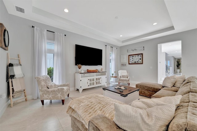 6317 Turtle Grass Dr, Bradenton, FL 34210 - living room featuring a raised ceiling, plenty of natural light, recessed lighting, and light tile patterned floors