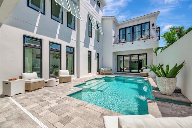 6317 Turtle Grass Dr, Bradenton, FL 34210 - rear view of property featuring a balcony, an outdoor hangout area, stucco siding, a patio area, and an outdoor pool