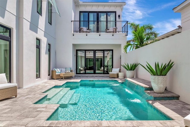 6317 Turtle Grass Dr, Bradenton, FL 34210 - rear view of house featuring a balcony, stucco siding, a patio, an outdoor pool, and french doors