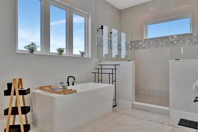 6317 Turtle Grass Dr, Bradenton, FL 34210 - bathroom with a soaking tub, a walk in shower, and tile patterned floors