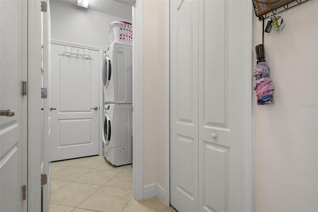 7750 Ridgelake Cir, Bradenton, FL 34203 - laundry room featuring stacked washer / drying machine and light tile patterned floors