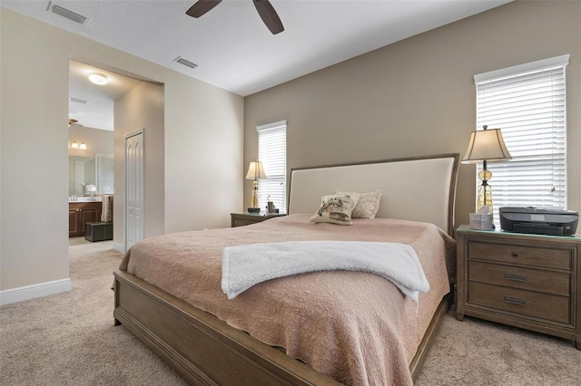 7750 Ridgelake Cir, Bradenton, FL 34203 - bedroom featuring light carpet, ensuite bath, and a ceiling fan