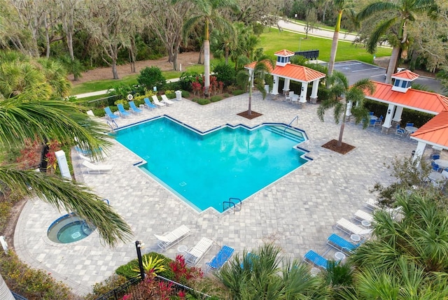 7750 Ridgelake Cir, Bradenton, FL 34203 - community pool featuring a gazebo, a hot tub, and a patio