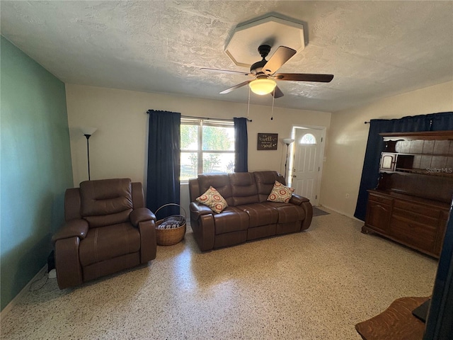 1224 38th St W, Bradenton, FL 34205 - living room featuring ceiling fan, speckle patterned floor, and a textured ceiling