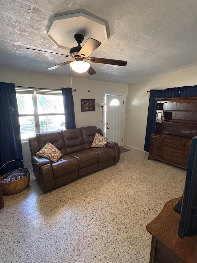 1224 38th St W, Bradenton, FL 34205 - living room featuring a textured ceiling, a ceiling fan, and speckle patterned floor