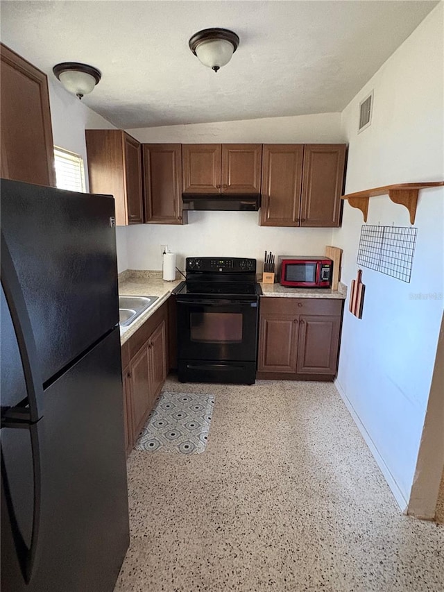 1224 38th St W, Bradenton, FL 34205 - kitchen with black appliances, light countertops, under cabinet range hood, and dark brown cabinetry