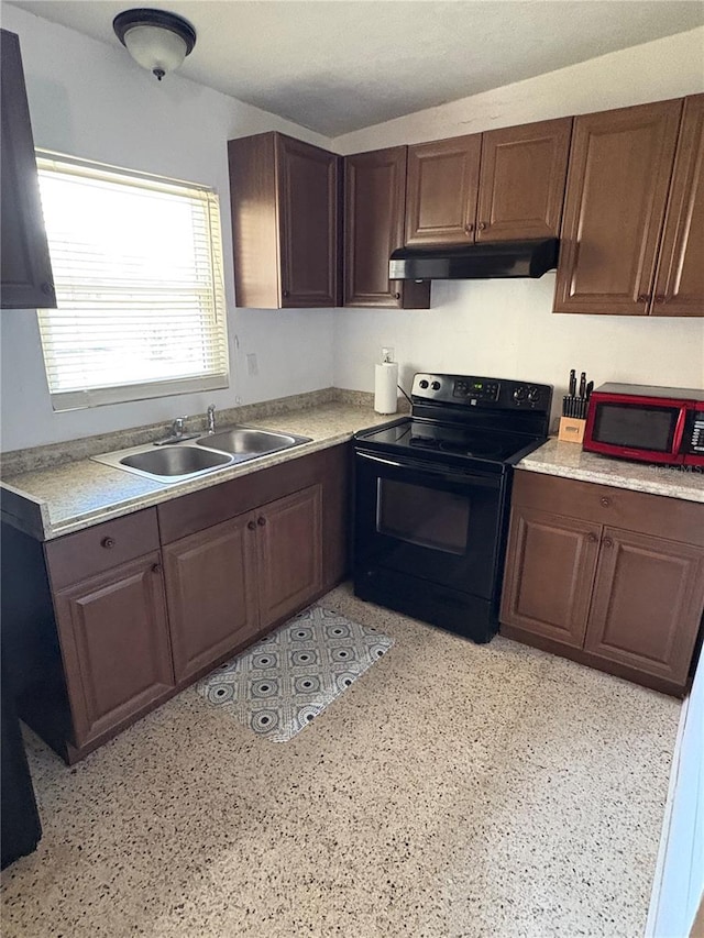 1224 38th St W, Bradenton, FL 34205 - kitchen with black electric range oven, under cabinet range hood, and light countertops