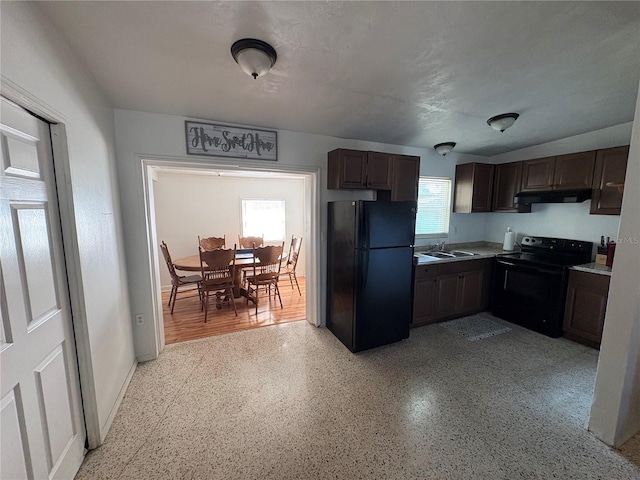 1224 38th St W, Bradenton, FL 34205 - kitchen featuring black appliances, under cabinet range hood, dark brown cabinets, and dark speckled floor
