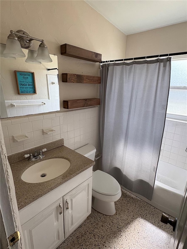 1224 38th St W, Bradenton, FL 34205 - full bath with vanity, shower / tub combo, tasteful backsplash, tile walls, and speckle patterned floor