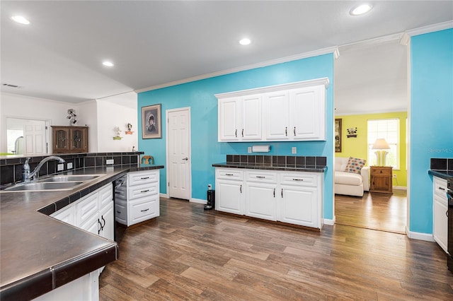 6710 36th Ave E Unit 114, Palmetto, FL 34221 - kitchen with dark countertops, white cabinetry, crown molding, dark wood-style floors, and recessed lighting