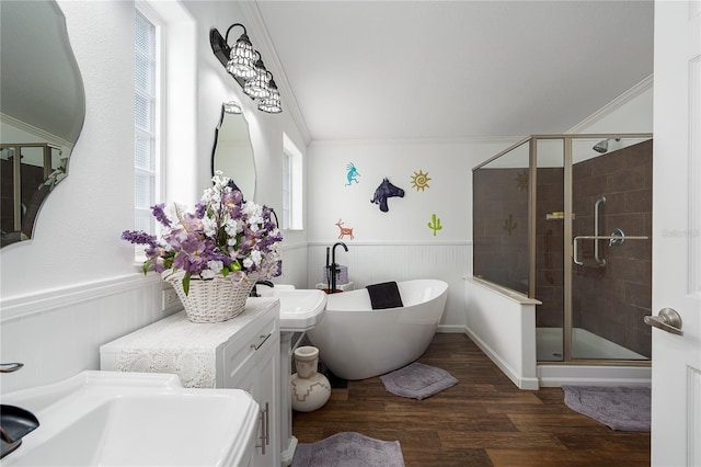 6710 36th Ave E Unit 114, Palmetto, FL 34221 - full bath featuring crown molding, wainscoting, a stall shower, a freestanding bath, and wood finished floors