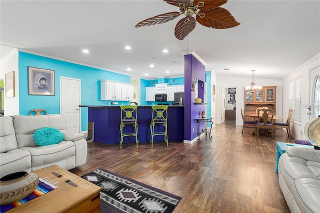 6710 36th Ave E Unit 114, Palmetto, FL 34221 - living area featuring ornamental molding, a ceiling fan, a chandelier, dark wood-type flooring, and recessed lighting