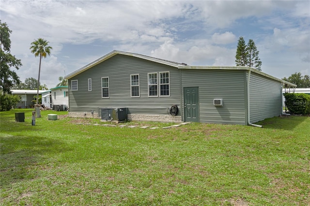 6710 36th Ave E Unit 114, Palmetto, FL 34221 - back of house with a yard and a wall mounted air conditioner