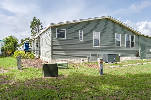 6710 36th Ave E Unit 114, Palmetto, FL 34221 - view of property exterior with a lawn and a central AC unit