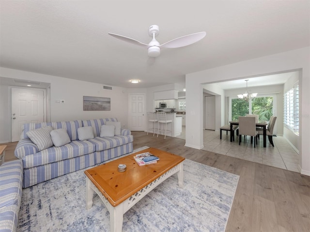 821 Montrose Dr Unit 103, Venice, FL 34293 - living room featuring light wood-type flooring, a chandelier, and ceiling fan