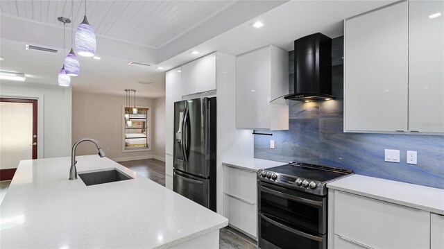3525 Riviera Dr, Sarasota, FL 34232 - kitchen featuring refrigerator with ice dispenser, modern cabinets, double oven range, wall chimney exhaust hood, and light wood finished floors