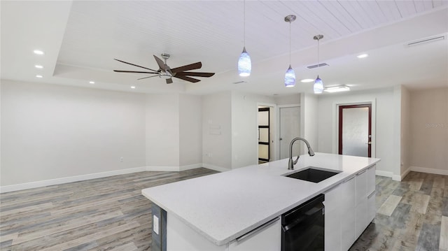 3525 Riviera Dr, Sarasota, FL 34232 - kitchen with black dishwasher, light wood-type flooring, recessed lighting, a ceiling fan, and white cabinets