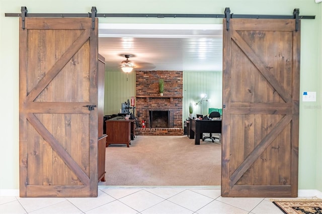 5311 36th Ave E, Palmetto, FL 34221 - living area with a barn door, light colored carpet, ceiling fan, and a brick fireplace