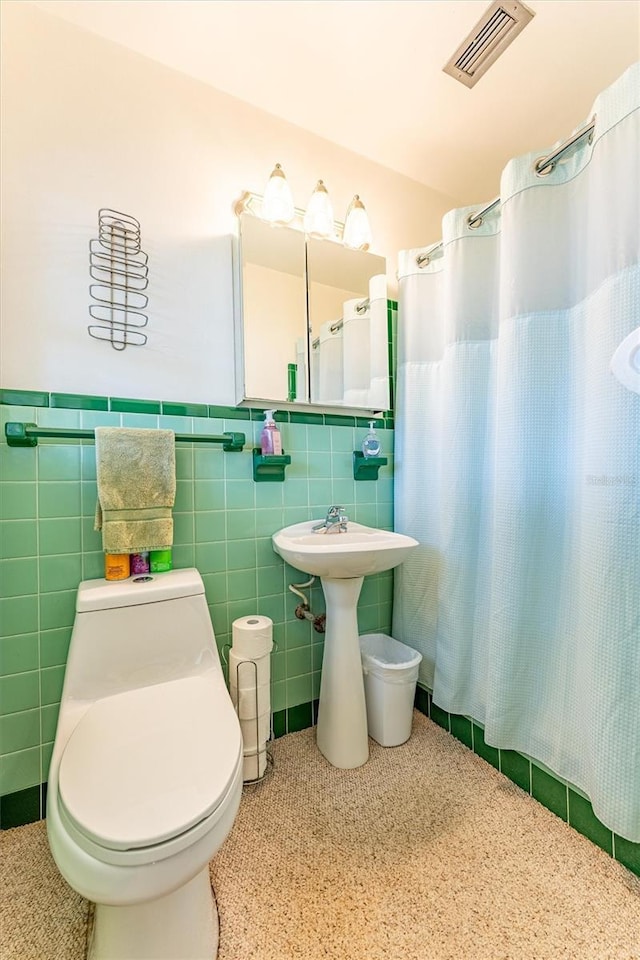 5311 36th Ave E, Palmetto, FL 34221 - bathroom with tile walls, wainscoting, and a shower with curtain