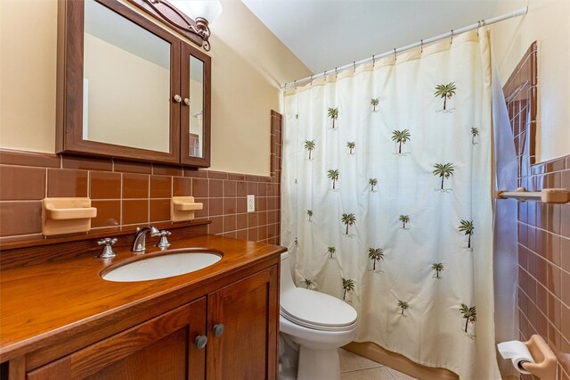 5311 36th Ave E, Palmetto, FL 34221 - bathroom with tile walls, vanity, tile patterned floors, and a shower with curtain