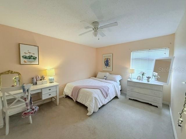 1959 Toucan Way Unit 206, Sarasota, FL 34232 - bedroom featuring light carpet, ceiling fan, and a textured ceiling