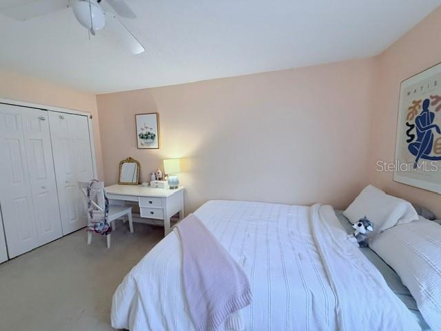 1959 Toucan Way Unit 206, Sarasota, FL 34232 - carpeted bedroom featuring ceiling fan and a closet