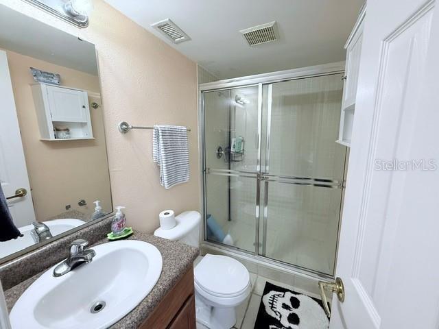 1959 Toucan Way Unit 206, Sarasota, FL 34232 - full bath featuring an enclosed shower and vanity