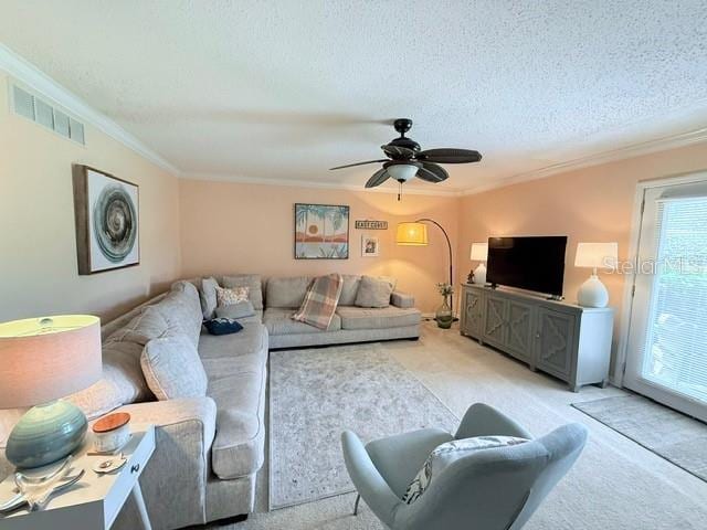 1959 Toucan Way Unit 206, Sarasota, FL 34232 - living area with crown molding, light colored carpet, a textured ceiling, and a ceiling fan