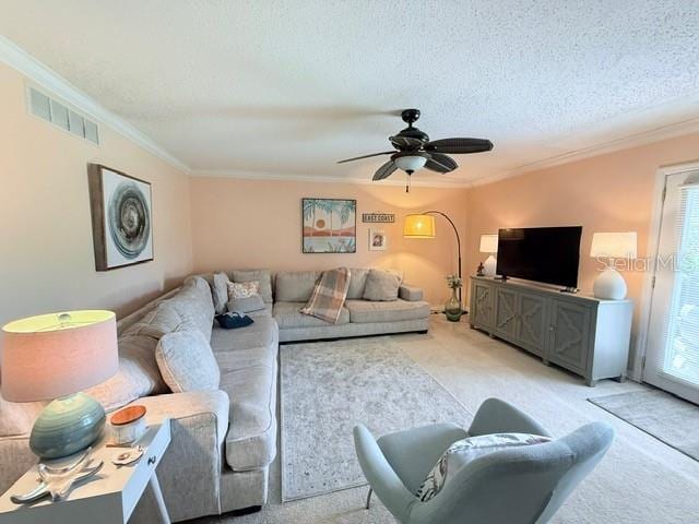 1959 Toucan Way Unit 206, Sarasota, FL 34232 - living room with light colored carpet, crown molding, a ceiling fan, and a textured ceiling