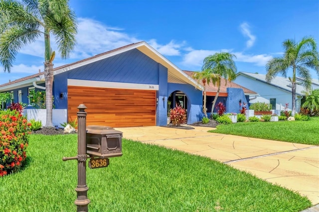 3636 Torrey Pines Blvd, Sarasota, FL 34238 - view of front facade with a garage, driveway, stucco siding, and a front yard