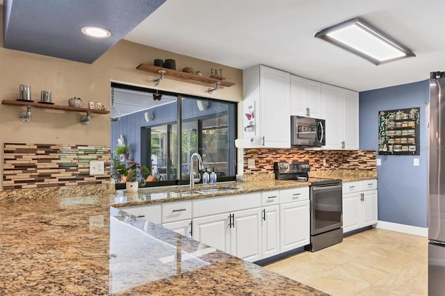 3636 Torrey Pines Blvd, Sarasota, FL 34238 - kitchen with stainless steel appliances, decorative backsplash, white cabinets, light stone counters, and recessed lighting