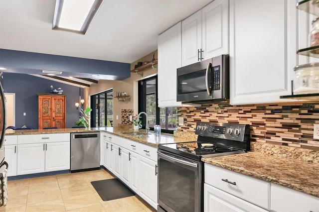 3636 Torrey Pines Blvd, Sarasota, FL 34238 - kitchen featuring appliances with stainless steel finishes, decorative backsplash, white cabinets, and light stone countertops