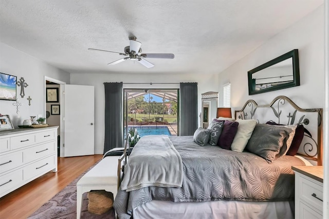 3636 Torrey Pines Blvd, Sarasota, FL 34238 - bedroom with access to outside, wood finished floors, a ceiling fan, and a textured ceiling