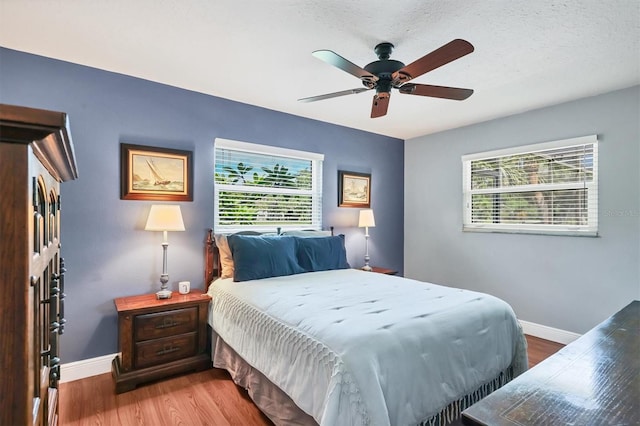 3636 Torrey Pines Blvd, Sarasota, FL 34238 - bedroom featuring multiple windows, wood finished floors, and ceiling fan