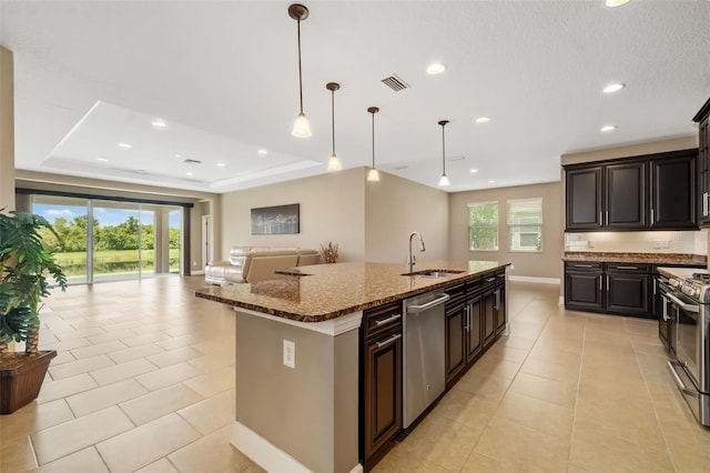 773 Rosemary Cir, Bradenton, FL 34212 - kitchen featuring stainless steel appliances, open floor plan, dark stone countertops, recessed lighting, and light tile patterned flooring